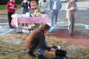 Nancy Herman-Thompson cooks old fashioned donuts over an open fire.